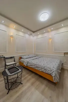 a bedroom with a bed and a chair in it at Megi Zemun Apartment in Zemun