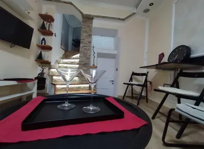 a table with two wine glasses on top of it at Megi Zemun Apartment in Zemun
