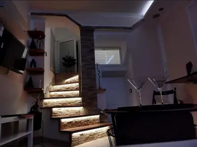 a set of stairs in a room with a window at Megi Zemun Apartment in Zemun