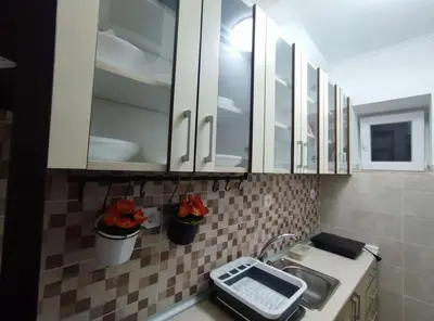 a kitchen with white cabinets and a sink at Megi Zemun Apartment in Zemun