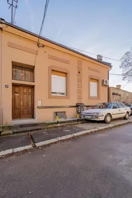a car parked in front of a building at Megi Zemun Apartment in Zemun