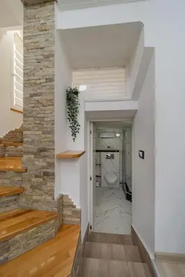 a hallway leading to a bathroom with a toilet at Megi Zemun Apartment in Zemun