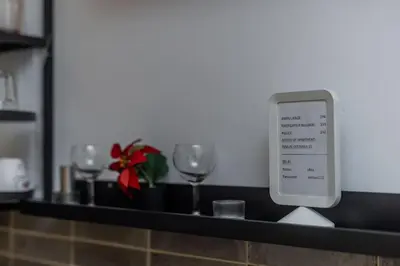 a counter with wine glasses and an ipod on it at Keti Zemun Spa Apartment in Zemun