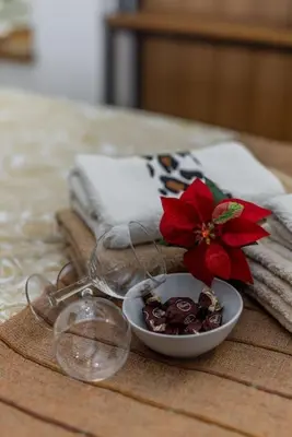a table with a bowl of food and a red flower at Keti Zemun Spa Apartment in Zemun
