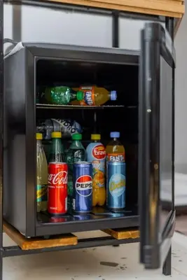 a small microwave with drinks inside of it at Keti Zemun Spa Apartment in Zemun