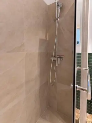 a shower with a glass door in a bathroom at Completely new, Bonbona Apartment Belgrade in Belgrade