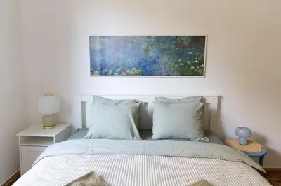 a bedroom with a bed with a painting above it at Completely new, Bonbona Apartment Belgrade in Belgrade