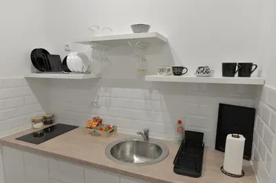 a kitchen with a sink and a counter with a sink at Andjela Apartments in Inđija