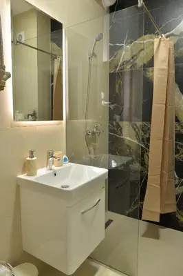 a bathroom with a white sink and a shower at Andjela Apartments in Inđija