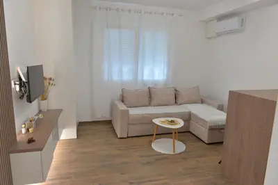 a living room with a couch and a table at Andjela Apartments in Inđija