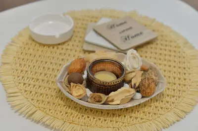 a plate of nuts and a candle on a table at Andjela Apartments in Inđija