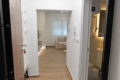 a hallway with a living room with a couch at Andjela Apartments in Inđija