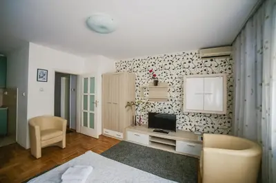 a living room with a tv on a wall at Apartment Stela in Belgrade