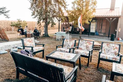 a group of chairs and tables in a yard at Ranč Elena in Ruma