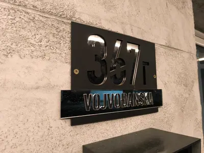 a sign on the side of a building that says vaughan way at Apartman Bika in Surčin
