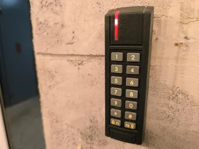 a black remote control hanging on a wall at Apartman Bika in Surčin