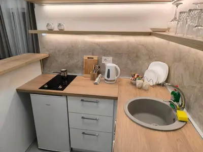 a small kitchen with a sink and a counter at Apartman Bika in Surčin