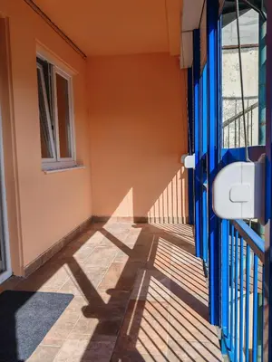 a hallway with a blue door and a window at Andrej 64 in Bežanija