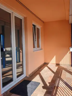 an empty porch of a house with sliding glass doors at Andrej 64 in Bežanija