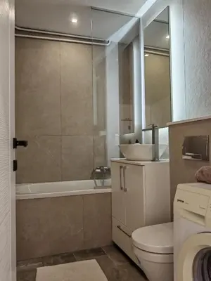 a bathroom with a toilet and a tub and a sink at Andrej 64 in Bežanija