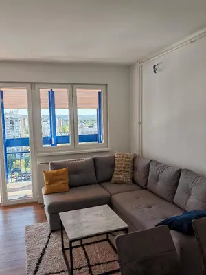 a living room with a couch and a table at Andrej 64 in Bežanija