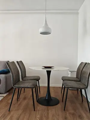 a table and chairs in a living room at Andrej 64 in Bežanija
