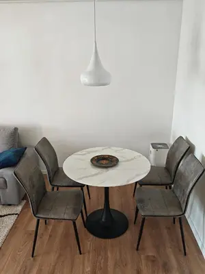a table and four chairs in a living room at Andrej 64 in Bežanija