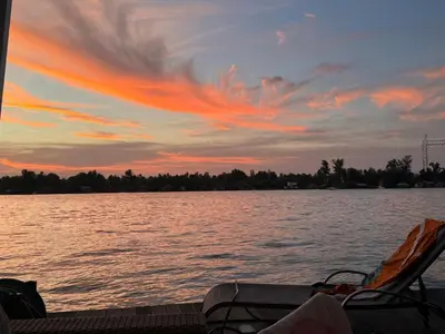a sunset over a body of water at Beautiful houseboat on the Sava river in Belgrade