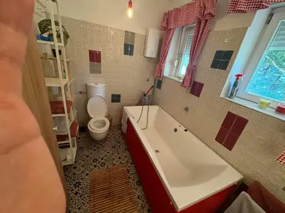 a bathroom with a toilet and a tub and a sink at Zvezda in Karaburma