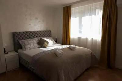 a bedroom with a bed with two towels on it at Airport Studio Stefan in Belgrade