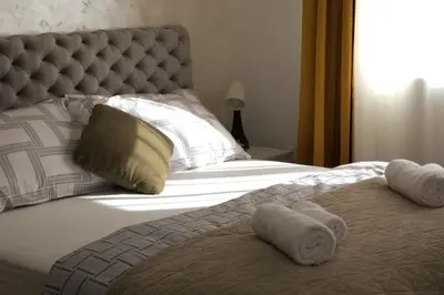 a bedroom with a bed with towels on it at Airport Studio Stefan in Belgrade