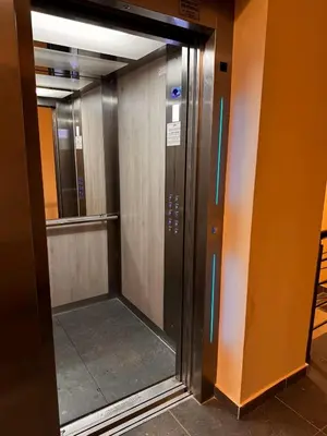 an elevator in a building with its door open at Apartman 69 in Krnjača