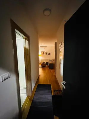 a hallway with a door leading to a living room at Apartman 69 in Krnjača