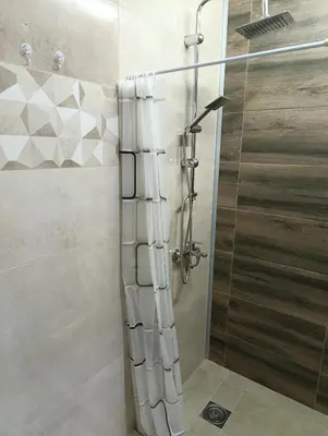 a shower with a glass door in a bathroom at Apartman Dora in Ruma