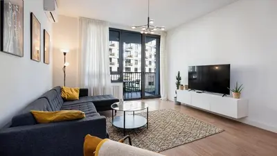 a living room with a couch and a tv at Belgrade Waterfront Quartet 1 in Belgrade