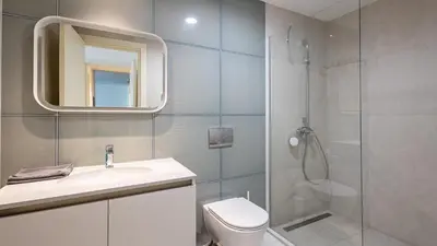 a bathroom with a shower and a sink and a toilet at Belgrade Waterfront Quartet 1 in Belgrade