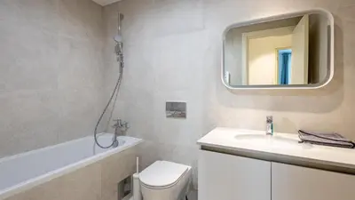 a bathroom with a toilet and a sink and a mirror at Belgrade Waterfront Quartet 1 in Belgrade