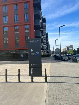a sign in a parking lot in front of a building at Belgrade Waterfront Quartet 1 in Belgrade