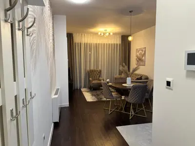 a dining room and living room with a table and chairs at Suzi in Belgrade