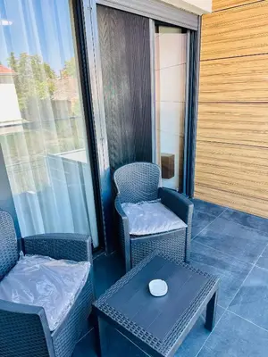 a balcony with two chairs and a table with aucer on it at Suzi in Belgrade