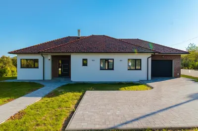 a white house with a driveway in front of it at Kosmaj IKIGAI in Nemenikuće