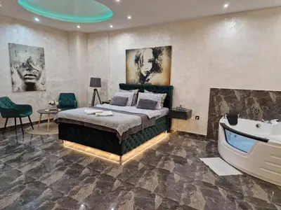 a bedroom with a bed and a bath tub at New Moment Lux in Žarkovo