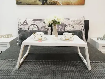 a white coffee table in a living room with a couch at New Moment Lux in Žarkovo