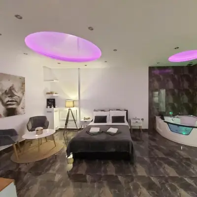 a bedroom with a large bed and a bath tub at New Moment Lux in Žarkovo