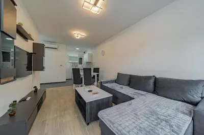 a living room with a couch and a table at Hemingway Belgrade Apartment in Zemun