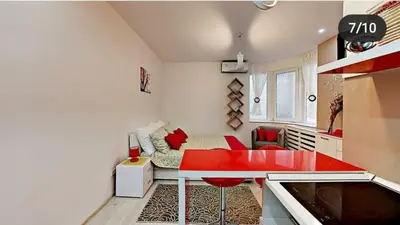 a small room with a red table and a bed at Terazije 3 in Belgrade