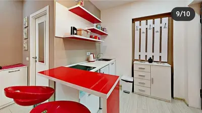 a small kitchen with a red counter and red stools at Terazije 3 in Belgrade