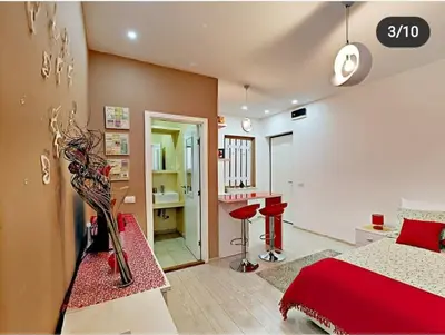 a bedroom with a red bed and a desk at Terazije 3 in Belgrade