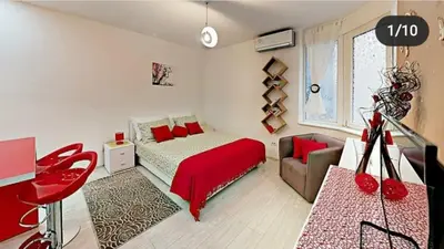 a bedroom with a red bed and a couch at Terazije 3 in Belgrade