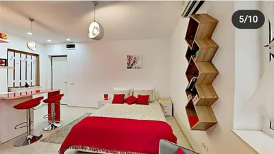 a bedroom with a red bed and a staircase at Terazije 3 in Belgrade